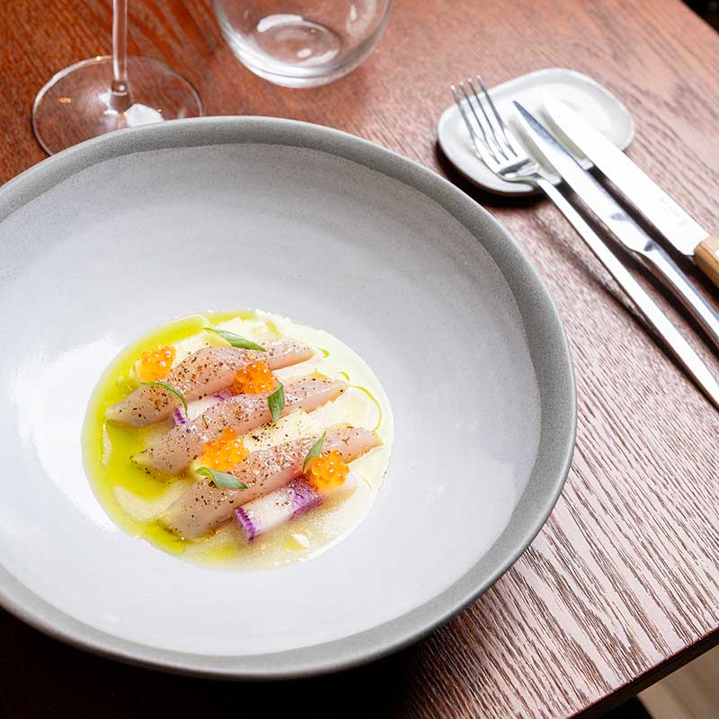 photographe-restaurants-culinaire-marseille-paca Photographe culinaire Marseille : salle de restaurant de luxe, tables nappées et cave à vin, reportage pro en Provence.